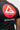 Detail of the red Barra Shield and Equipe wordmark over the tonal striped back graphic on the black Close Contact Rashguard.