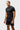 Three-quarter front view of the black Gracie Barra Close Contact Rashguard with the red Legacy G and Jiu-Jitsu chest print.