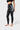 Side view of the black Close Contact Womens Compression Pants showing the white Gracie Barra print on the gray striped hip panel, ankle length.