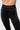 Detail of the red Gracie Barra wordmark on the elastic waistband of the black Close Contact Womens Compression Pants, with gray striped side panels.