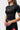 Angled front view of the black Close Contact Womens Rashguard showing the raglan sleeve construction and slightly tapered waist.
