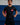 Model wearing the black Continuum Rashguard by VG, front view with the red Gracie Barra shield on the chest and orange EQUIPE print at the shoulder.