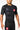 Three-quarter front view of the black Gracie Barra Continuum Rashguard by VG with red Barra Shield chest patch and tonal Vanguard print down the sleeve.