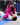 Two young Gracie Barra students in a Jiu-Jitsu match, one in a pink kimono controlling an opponent in white on the mat.