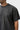 Close-up of the tonal black Stacked Gracie Barra embroidered emblem on the chest of the garment-dyed washed black Emblem Tee.