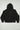 Back view of the black Gracie Barra Emblem women’s hoodie laid flat on a white background, featuring the Legacy G graphic centered on the upper back and a red Gracie Barra sleeve tag.