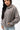 Emblem Womens Hoodie in Gray — front view on model showing the tonal Gracie Barra chest emblem and oversized fit, worn with light-wash jeans.