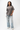 Emblem Womens Tee, grey — full-length front view, relaxed oversized fit with burgundy embroidered Gracie Barra chest emblem, styled with light-wash jeans and white sneakers.