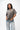 Emblem Womens Tee, grey — front three-quarter view showing the relaxed oversized fit and burgundy embroidered Gracie Barra chest emblem.