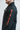 Red vertical GRACIE BARRA print down the sleeve of the black Equipe windbreaker, side view with elasticated cuff.