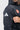 Close-up of the white adidas logo on the sleeve and red Barra Shield patch on the chest of the black Equipe Zip Hoodie by adidas.
