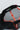 Interior view of the black Equipe Motion Cap showing breathable mesh lining, red Jiu-Jitsu and Equipe branded taping, and a Barra da Tijuca origin label stitched inside the sweatband, photographed flat on a white background.