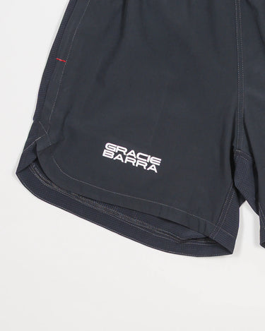 Close-up of the Equipe Motion Men’s Shorts in grey, showing the Gracie Barra stacked logo, side vent hem with reinforced bar-tack stitching, and lightweight quick-dry fabric.