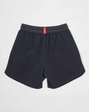 Back view of the Equipe Motion Men’s Shorts in grey, featuring an elastic waistband with reinforced stitching, a red woven brand tab, and lightweight quick-dry fabric.