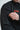 Zippered sleeve pocket on the arm of the black Equipe Warm Up Jacket, shown beside the stacked orange Gracie Barra chest logo.
