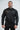 Black Gracie Barra Equipe Warm Up Jacket, front view, with stacked orange Gracie Barra chest logo, full-length zipper and gray EQUIPE sleeve print.