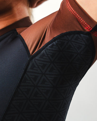 GB Essentials Women’s Brown Belt Ranked Rashguard sleeve and underarm close-up highlighting geometric side panels and reinforced stitching.