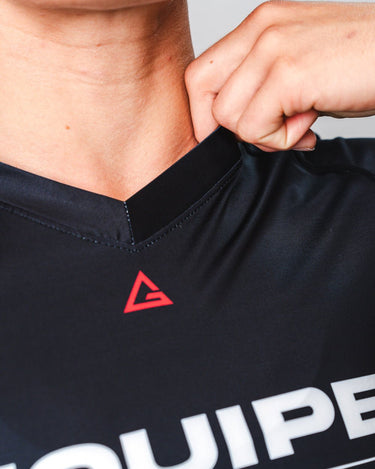 GB Essentials Women’s Ranked Rashguard in black, close-up of neckline with Legacy G logo and EQUIPE front branding.
