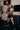 Side profile of army green sleeveless tech tee showing the body fit and open sleeveless armhole during a standing cable exercise.