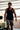 Front view of black tech tank with a scoop neckline, open-arm cut, and the rubberized Red Shield logo on the left chest.