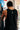 Back view of black tech tank with an open-arm cut and a contrast white Jiu-Jitsu print running vertically down the upper back.