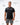 Flow Men's Tech Tee in black, full-length front view on a male model with the white Gracie Barra Stacked logo on the left chest