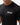 Flow Men's Tech Tee in black, chest close-up showing the white Gracie Barra Stacked logo on the left chest and the crew neckline