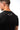 Flow Men's Tech Tee in black, over-the-shoulder back close-up showing the white Brazilian Jiu-Jitsu graphic on the upper back