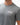Flow Men's Tech Tee in dark grey, chest close-up showing the white Gracie Barra Stacked logo on the left chest and the crew neckline