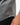 Flow Men's Tech Tee in dark grey, close-up of the curved hem and stitched side seam