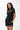 Flow Women's Tech Tee in black, full-length front view on a female model with the white Gracie Barra Stacked logo on the left chest