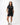 Flow Women's Tech Tee in black, full-length front view on a female model with hands in her pockets, white Gracie Barra Stacked logo on the left chest