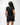 Flow Women's Tech Tee in black, full-length back view on a female model showing the small white Brazilian Jiu-Jitsu graphic on the upper back