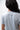 Flow Women's Tech Tee in light grey, back close-up showing the small dark Brazilian Jiu-Jitsu graphic on the upper back
