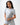 Flow Women's Tech Tee in light grey, full-length front view on a female model with the black Gracie Barra Stacked logo on the left chest