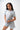 Flow Women's Tech Tee in light grey, full-length front view on a female model with the black Gracie Barra Stacked logo on the left chest