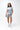 Flow Women's Tech Tee in light grey, full-length front view on a female model with one hand in her pocket, dark Gracie Barra Stacked logo on the left chest
