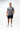 Frame Men's Short in black, full-length front view on a male model with one hand in the side pocket, white Gracie Barra Stacked logo on the lower left leg