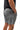 Frame Men's Short in dark grey, three-quarter back view showing the zippered back pocket and side hem vent, with a hand in the side pocket