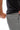 Frame Men's Short in dark grey, close-up of a model opening the zippered front pocket, with the front seam visible