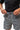 Frame Men's Short in dark grey, front waistband close-up of a model tying the drawstring on the elastic waistband