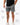 Frame Men's Short in dark grey, lower-body front view on a male model with the white Gracie Barra Stacked logo on the lower left leg