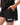 Frame Women's Short in black, lower-body close-up with a hand in the side pocket, side hem vent, and the white Gracie Barra Stacked logo on the lower left leg