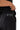 Frame Women's Short in black, back close-up showing the white Brazilian Jiu-Jitsu graphic above the back pocket, with a hand lifting the tee hem