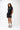 Frame Women's Short in black, full-length front view on a female model with one hand in the pocket, white Gracie Barra Stacked logo on the lower left leg