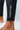 Close-up of the ankle cuff on black GB Essentials compression pants with vertical white EQUIPE print and small GB logo