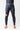 Model wearing black GB Essentials compression pants, front view showing Gracie Barra waistband and red logo on the left thigh