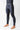 Side angle view of model wearing black GB Essentials compression pants, showing tapered leg fit and EQUIPE print near the ankle