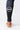 Close-up of the lower leg in black GB Essentials compression pants showing the white circular GB logo on the calf