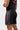 Side and back angle of the black Velcro Training Shorts showing the red BARRA side panel print and the vented split hem.